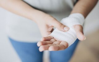 Woman with a bandaged hand.