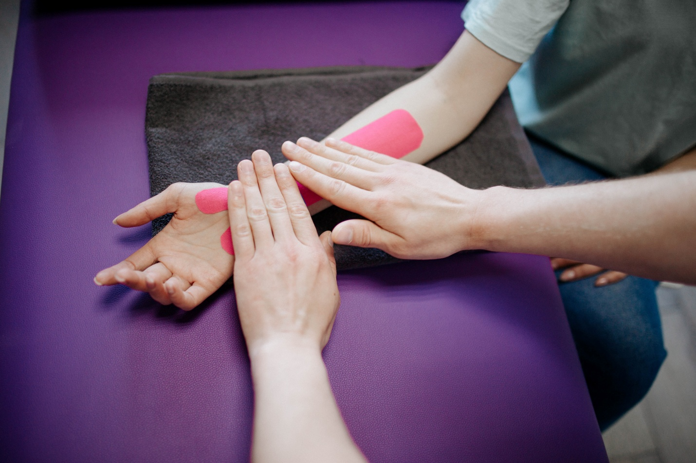 A hand therapist massage the forearm of a patient at the hand therapy clinic in NJ
